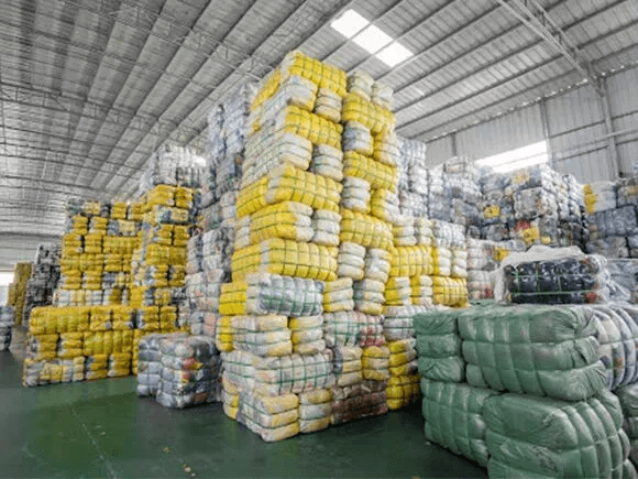 Bales of used clothes in a factory